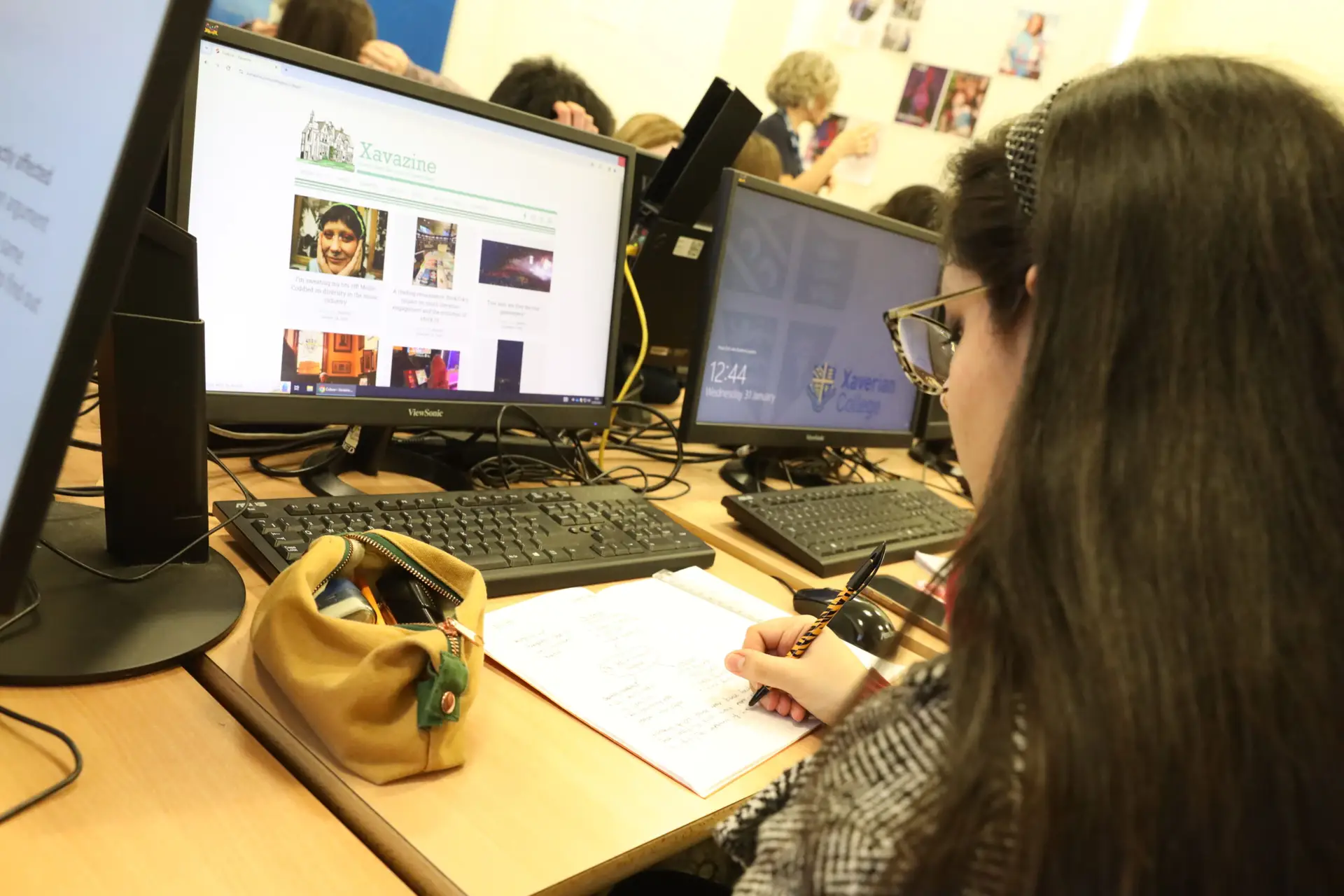 A student editing a magazine on a computer